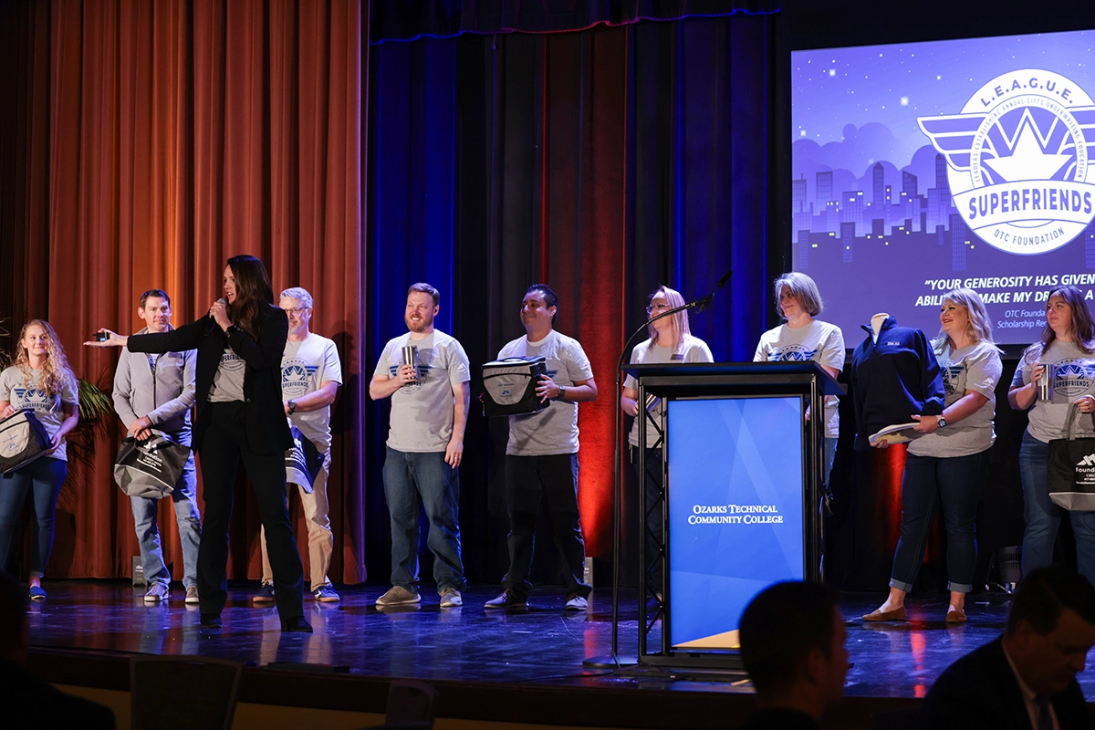 Employees on stage during College Development Day
