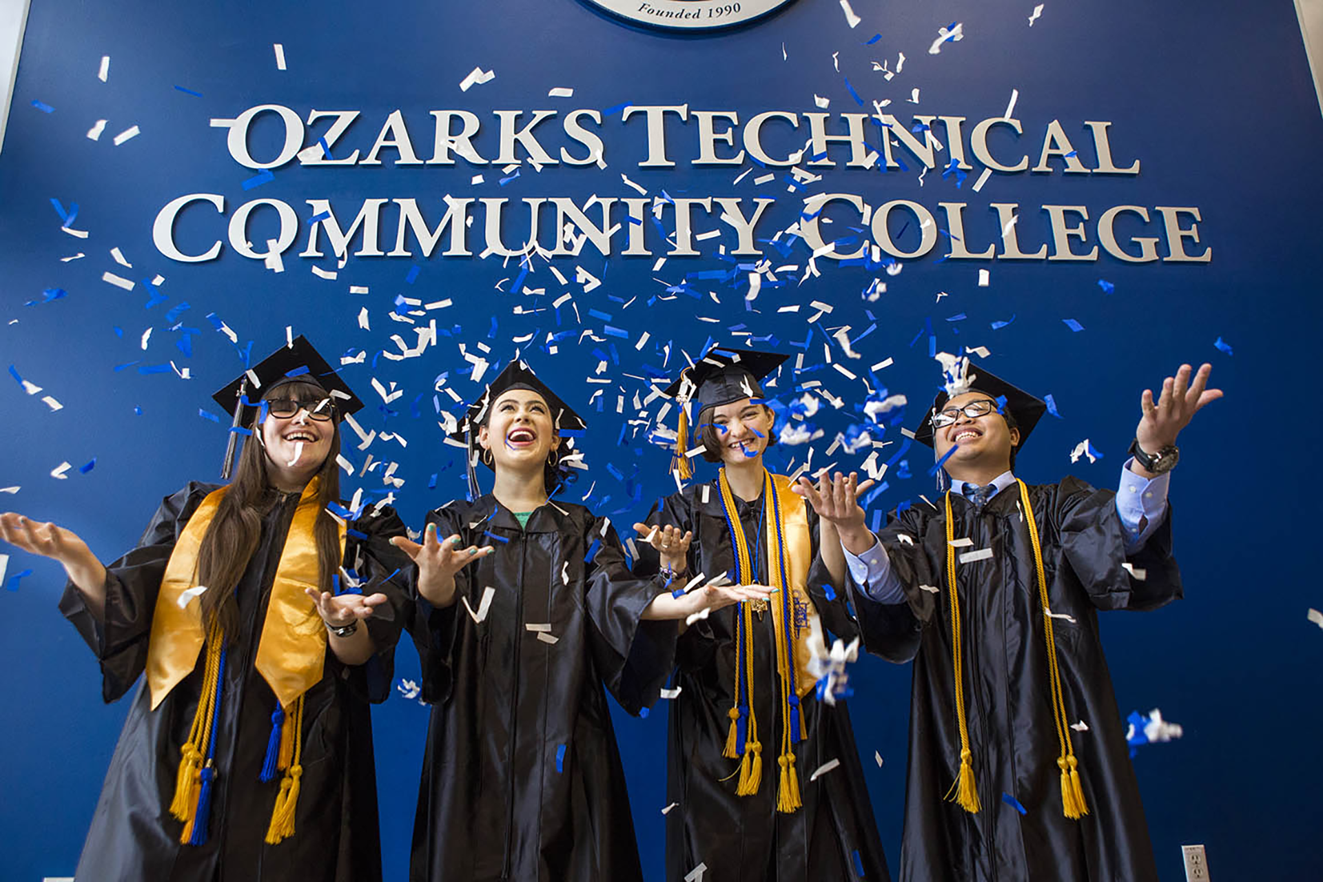 Students in caps and gowns celebrating