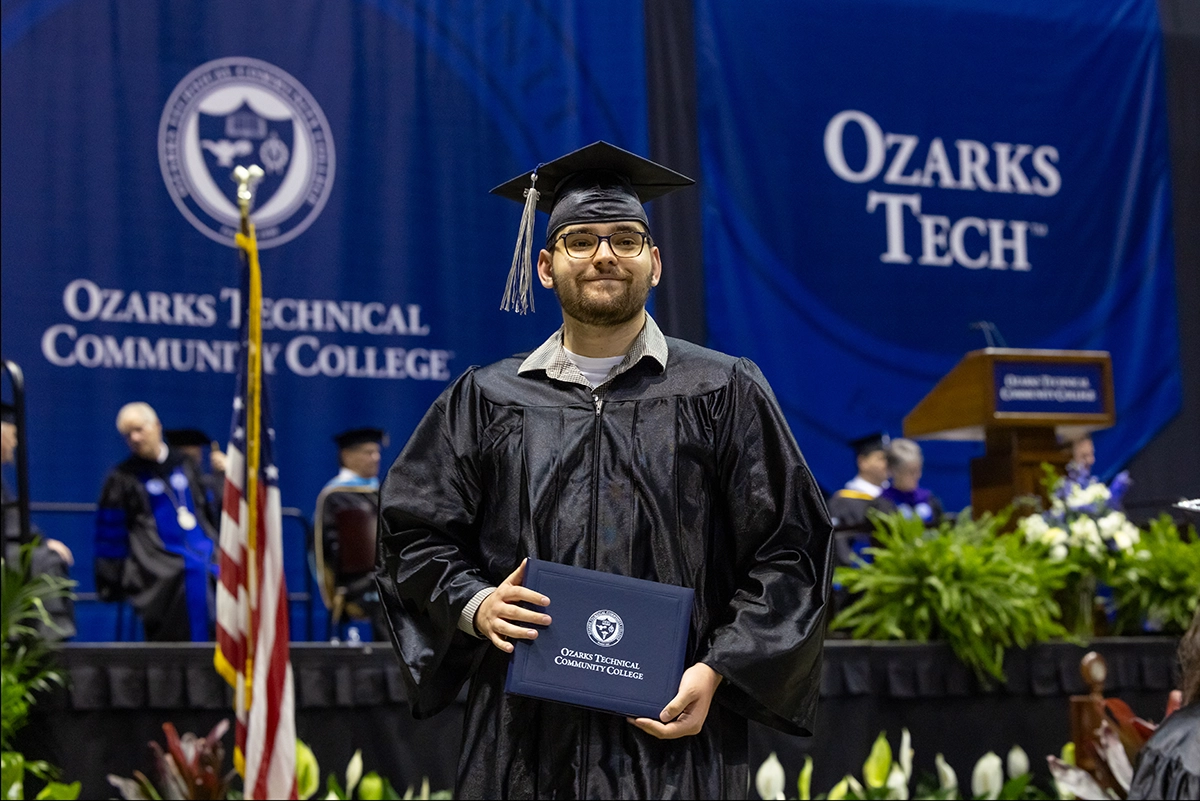 Graduate holding diploma holder